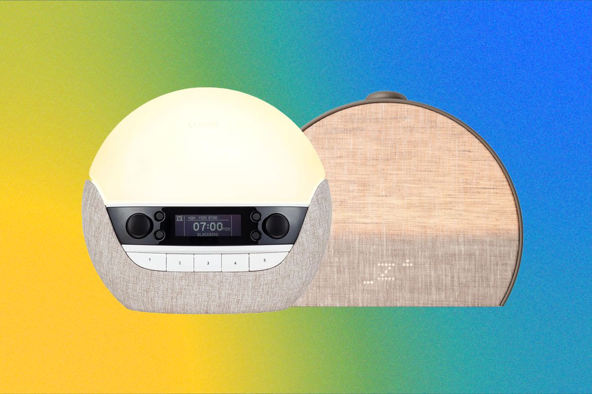 A cozy bedroom with a sunrise alarm clock glowing softly